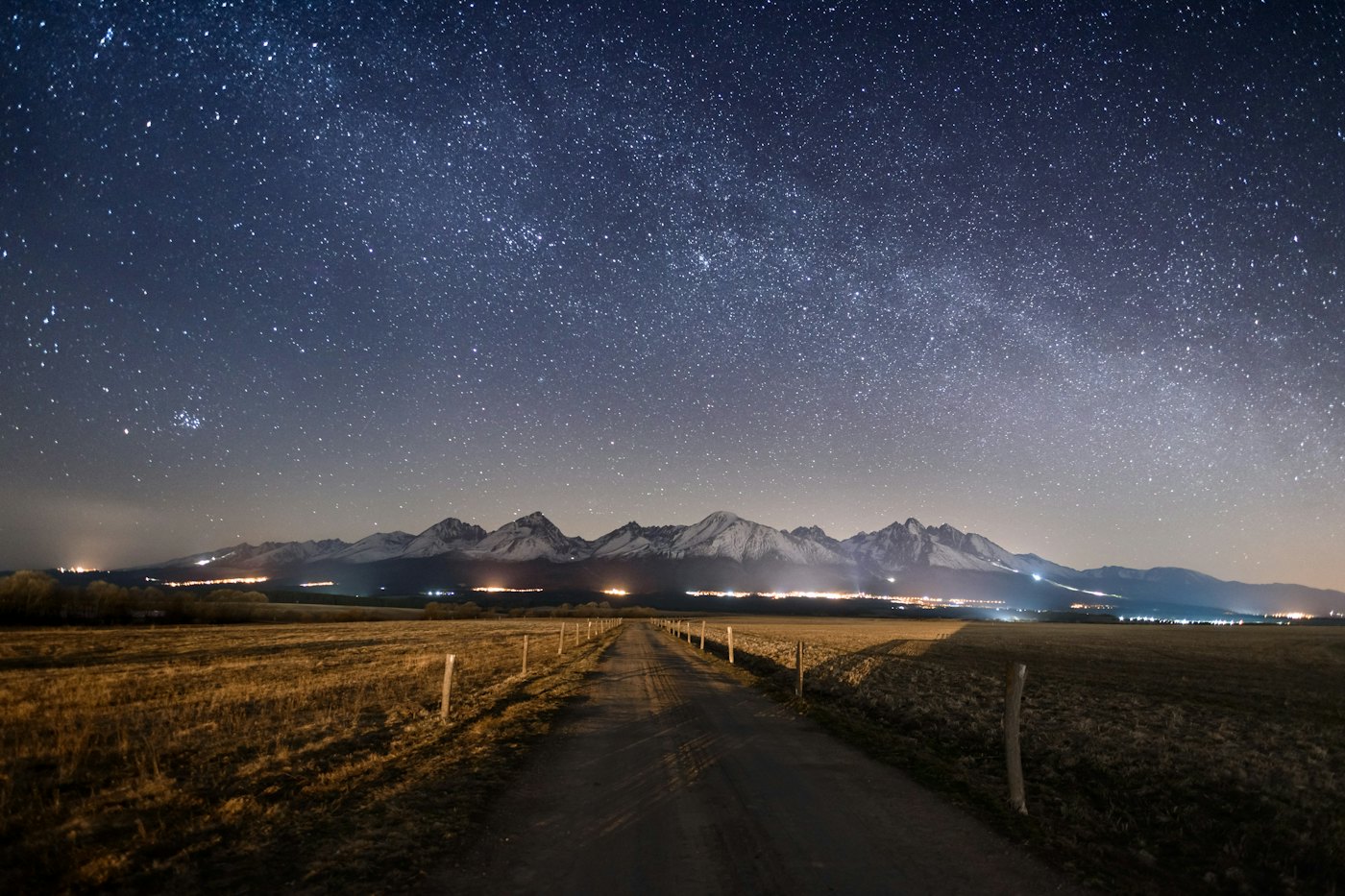 The High Tatras under a sky full of stars, seen from a country lane